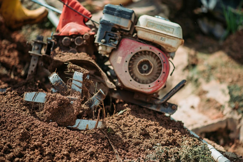 close up shot of hand tractor plowing the soil fields